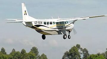 Light aircraft over East African wilderness during fly-in safari.