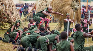 Tourist on a cultural safari in Rwanda, engaging with local traditions after a Gorilla Trekking in Volcanoes.
