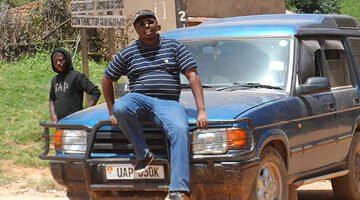 Travel planner outside office planning a custom safari itinerary for Uganda and Rwanda adventures.